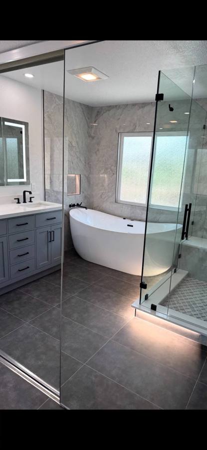 Modern bathroom remodel with freestanding tub and glass shower